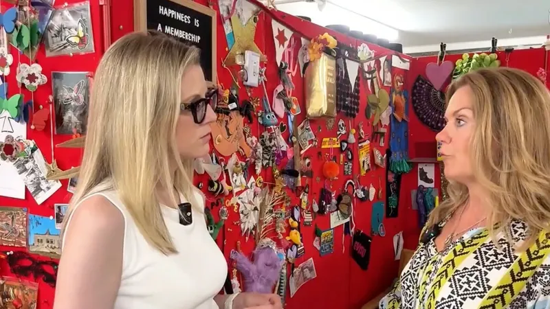An ITV News reporter interviewing a Scrapstore team member inside the store